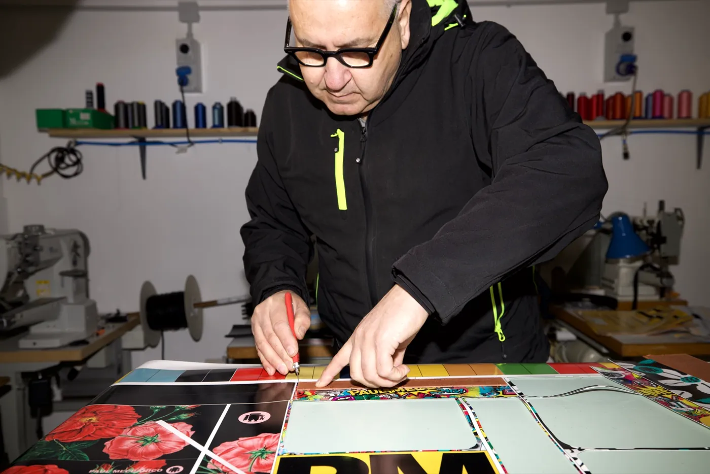 Paul at work in the Paul Meccanico workshop, cutting printed material by hand